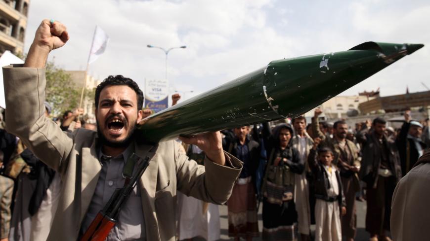 A Houthi follower carries a mock missile as he shouts slogans during a demonstration against the United Nations in Sanaa, Yemen, July 5, 2015. Hundreds of supporters of the Iran-backed Houthi rebels took to the streets of the Yemeni capital on Sunday to protest against the United Nations and its alleged support of Yemen's exiled President Abd-Rabbu Mansour Hadi. REUTERS/Mohamed al-Sayaghi - GF10000149438