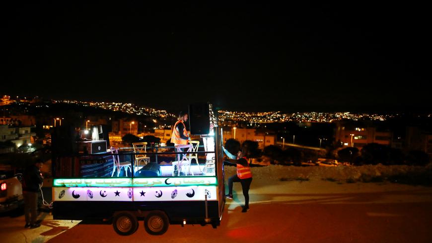 A festive Ramadan float drives through a street in East Jerusalem to bring celebrations to people under the coronavirus disease (COVID-19) movement restrictions, May 3, 2020. Picture taken on May 3, 2020 REUTERS/ Ammar Awad - RC2NHG90NRE2