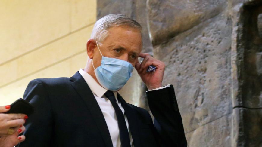 Blue and White party leader Benny Gantz wears a protective face mask on his way to the swearing-in ceremony of a new unity government in the Knesset (Israel's parliament) in Jerusalem May 17, 2020. Alex Kolomoisky/Pool via REUTERS - RC2DQG90APEQ