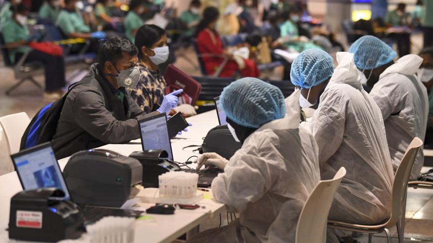 Members of an Indian medical team register for testing upon their arrival at Dubai International Airport on May 9, 2020, to help with the coronavirus (COVID-19) pandemic. (Photo by Karim SAHIB / AFP) (Photo by KARIM SAHIB/AFP via Getty Images)