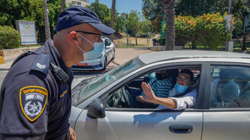 Israeli police man a checkpoint at the entrance of the central Israeli Elad city on June 24, 2020, as the government imposed a partial lockdown on several neighbourhoods following a recent increase in coronavirus cases. (Photo by AHMAD GHARABLI / AFP) (Photo by AHMAD GHARABLI/AFP via Getty Images)