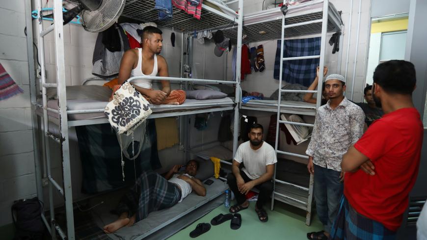 Migrant workers from Bangladesh, working for waste management company RAMCO, gather inside their dormitory at a company facility in Biakout, near Beirut, Lebanon, May 20, 2020. Picture taken May 20, 2020. REUTERS/Mohamed Azakir - RC2MTG927AFE