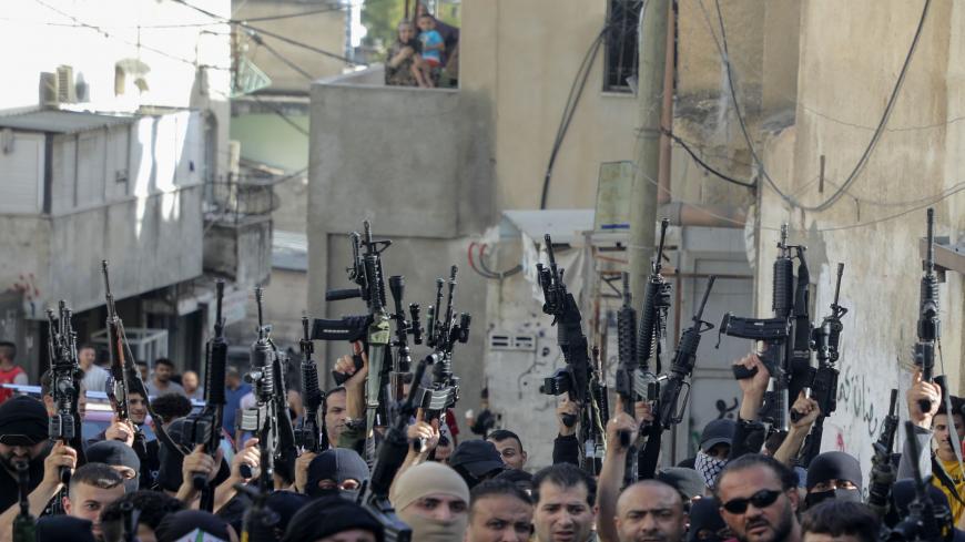 TOPSHOT - Armed members of the Palestinian Fatah movement take part in a march in the Al-Ain camp, west of Nablus in the West Bank, on June 7, 2020, to protest Israel's plan to annex parts of the occupied Palestinian territory and express support for President Mahmoud Abbas. (Photo by JAAFAR ASHTIYEH / AFP) (Photo by JAAFAR ASHTIYEH/AFP via Getty Images)