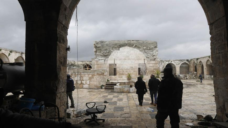 Syrian pro-regime fighters and journalists enter the courtyard of the museum of Maaret al-Numan in Syria's northwestern Idlib province on January 30, 2020. - Maaret al-Numan is nestled in a UNESCO-listed region of ancient villages and its mosaics museum had achieved international renown.
The museum, housed in an Ottoman-era caravanserai, was seriously damaged in a government barrel bomb attack in 2015. (Photo by LOUAI BESHARA / AFP) (Photo by LOUAI BESHARA/AFP via Getty Images)