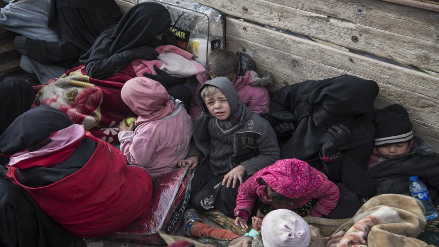 Women and children who fled the Islamic State (IS) group's embattled holdout of Baghouz on February 14, 2019, wait in the back of a truck in the eastern Syrian province of Deir Ezzor. - IS jihadists using tunnels and suicide bombers were mounting a desperate defence today of their last square kilometre in eastern Syria.
Kurdish-led forces closed in on the small town of Baghouz where IS fighters and their relatives were hunkered down and met famished and dishevelled people turning themselves in. (Photo by Fa