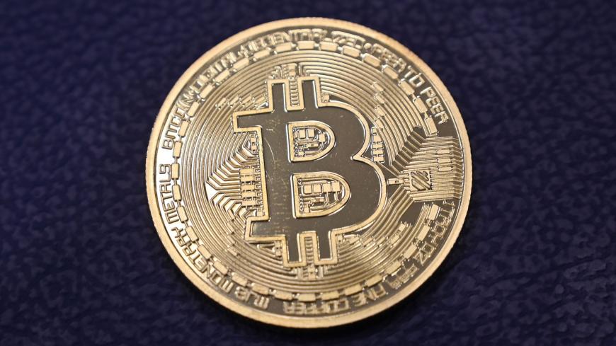 This photograph taken on December 17, 2020 shows shows a physical imitation of a Bitcoin at a crypto currency "Bitcoin Change" shop, near Grand Bazaar, in Istanbul. - Leading virtual currency bitcoin on 16 December traded above $20,000 for the first time following a sustained run higher in recent weeks. Bitcoin reached a record-high $20,398.50 before pulling back to $20,145, which was still an intra-day gain of nearly four percent. (Photo by Ozan KOSE / AFP) (Photo by OZAN KOSE/AFP via Getty Images)