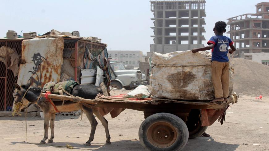 A Yemeni youth stands in the back of a transport donkey cart in the southern city of Aden, on September 16, 2020. - Yemenis are resorting to using donkeys to transport water and haul goods, as the long years of conflict that have ravaged the economy make gas-guzzling vehicles unaffordable for many. (Photo by Saleh Al-OBEIDI / AFP) (Photo by SALEH AL-OBEIDI/AFP via Getty Images)