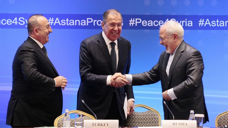 Russian Foreign Minister Sergei Lavrov (C) shakes hands with Iranian Foreign Minister Mohammad Javad Zarif (R) and Turkish Foreign Minister Mevlut Cavusoglu following their talks on Syria in Astana on March 16, 2018. / AFP PHOTO / Alexey FILIPPOV        (Photo credit should read ALEXEY FILIPPOV/AFP via Getty Images)