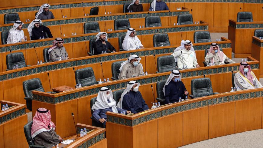 Kuwaiti members of parliament attend a special session following-up on measures undertaken by the government of limit the spread of COVID-19 coronavirus disease, at the National Assembly headquarters in Kuwait City on February 16, 2021. (Photo by YASSER AL-ZAYYAT / AFP) (Photo by YASSER AL-ZAYYAT/AFP via Getty Images)