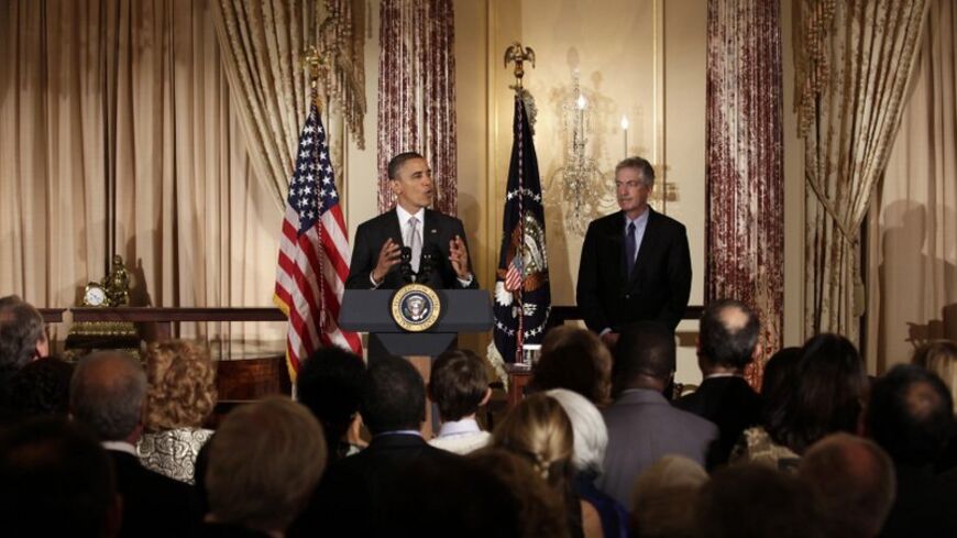 U.S. President Barack Obama delivers remarks next to Deputy Secretary of State William Burns at the Diplomatic Corps holiday reception at the State Department in Washington December 19, 2012.  REUTERS/Yuri Gripas (UNITED STATES - Tags: POLITICS) - RTR3BRHD