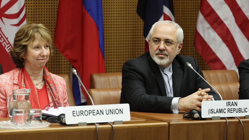 European Union foreign policy chief Catherine Ashton (L) and Iranian Foreign Minister Mohammad Javad Zarif wait for the start of talks in Vienna April 9, 2014. Six world powers and Iran will need "a lot of intensive work" to bridge differences during talks over Tehran's nuclear programme, Ashton said on Wednesday after their latest meeting. REUTERS/Heinz-Peter Bader  (AUSTRIA - Tags: POLITICS ENERGY) - RTR3KKPD