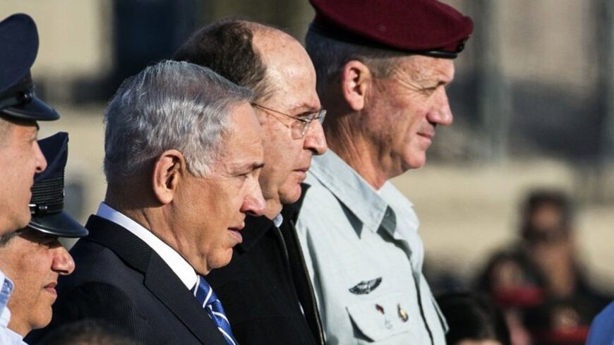 Israeli Prime Minister Benjamin Netanyahu (C) stands next to Defence Minister Moshe Ya'alon (2nd R) and Chief of the General Staff Lieutenant General Benny Gantz (R) during an air force pilots' graduation ceremony at Hatzerim air base in southern Israel December 26, 2013. REUTERS/Nir Elias (ISRAEL - Tags: MILITARY POLITICS) - RTX16UGX
