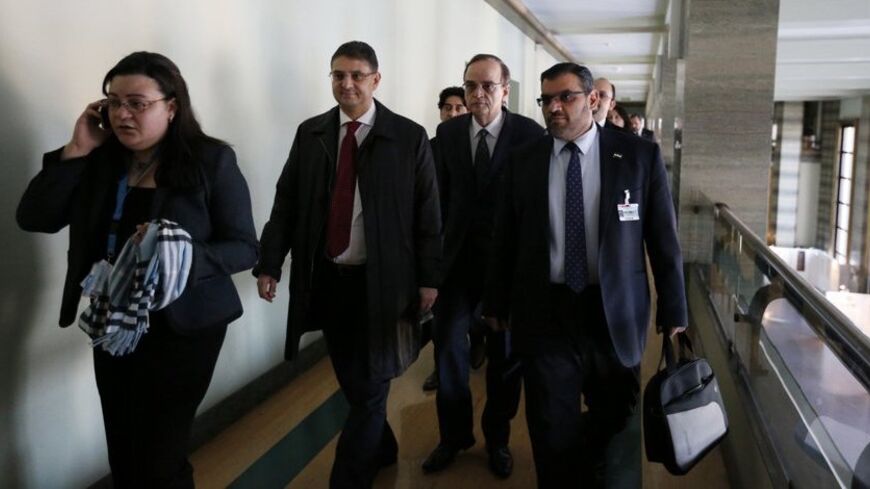 Syrian opposition delegation arrive for a meeting with U.N.-Arab League envoy for Syria Lakhdar Brahimi (not seen) at a U.N. office in Geneva January 24, 2014. REUTERS/Jamal Saidi (SWITZERLAND - Tags: POLITICS CIVIL UNREST) - RTX17SPH