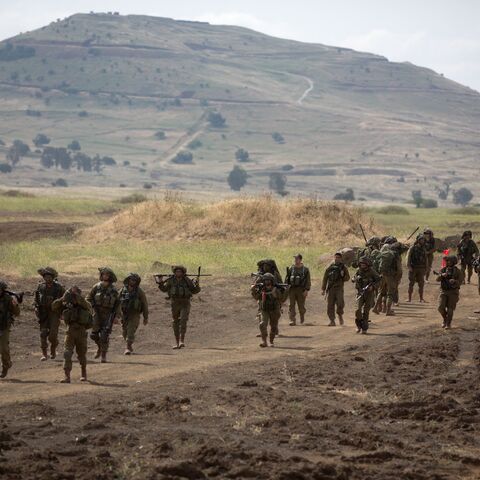 Israeli soldiers of the Jewish Ultra-Orthodox battalion "Netzah Yehuda" take part in their annual unit training in the Israeli annexed Golan Heights, near the Syrian border on May 19, 2014. The Netzah Yehuda Battalion is a battalion in the Kfir Brigade of the Israel military which was created to allow religious Israelis to serve in the army in an atmosphere respecting their religious convictions. AFP PHOTO/MENAHEM KAHANA (Photo credit should read MENAHEM KAHANA/AFP via Getty Images)