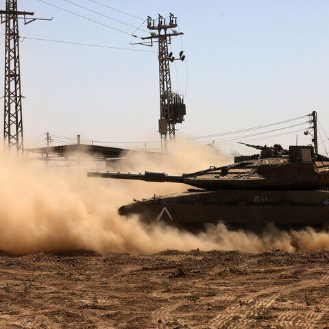 An Israel tank rolls near the border with the Gaza Strip on May 2, 2024, amid the ongoing conflict between Israel and the Palestinian Hamas movement. (Photo by Menahem KAHANA / AFP) (Photo by MENAHEM KAHANA/AFP via Getty Images)
