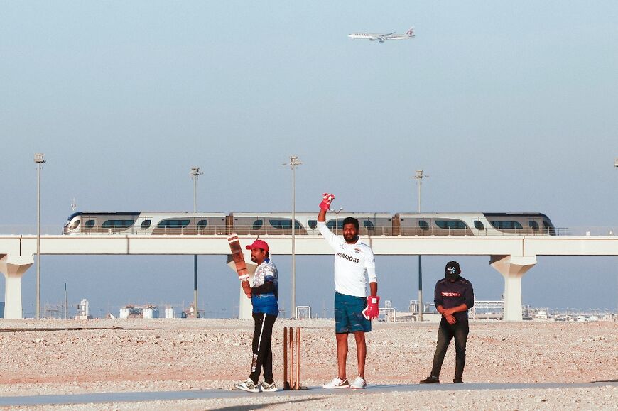 Indian expats play cricket alongside the metro in Al-Wakra City, just south of Doha