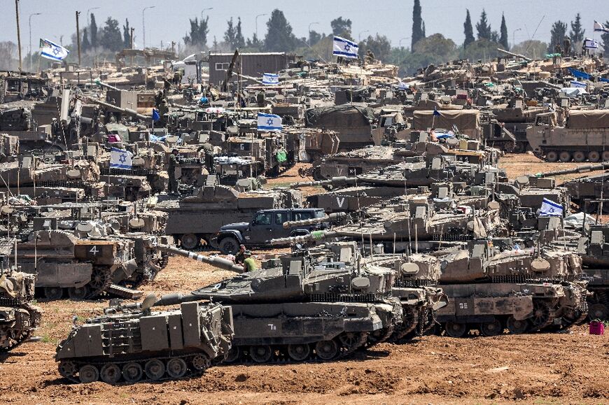 Israeli army main battle tanks and other military vehicles are positioned in southern Israel near Gaza, where tanks have already been sent in to the Rafah area