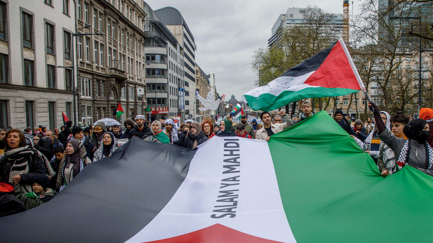 Demonstrators hold a giant Palestinian flag during the 'Justice for Palestine' rally in solidarity with the Palestinian people in Brussels on March 17, 2024. (Photo by HATIM KAGHAT / Belga / AFP) / Belgium OUT (Photo by HATIM KAGHAT/Belga/AFP via Getty Images)