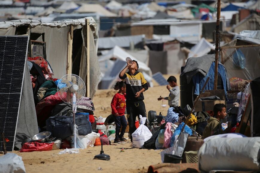 Displaced Palestinians gather their belongings before leaving Al-Mawasi to a safer area in Rafah in the southern Gaza Strip