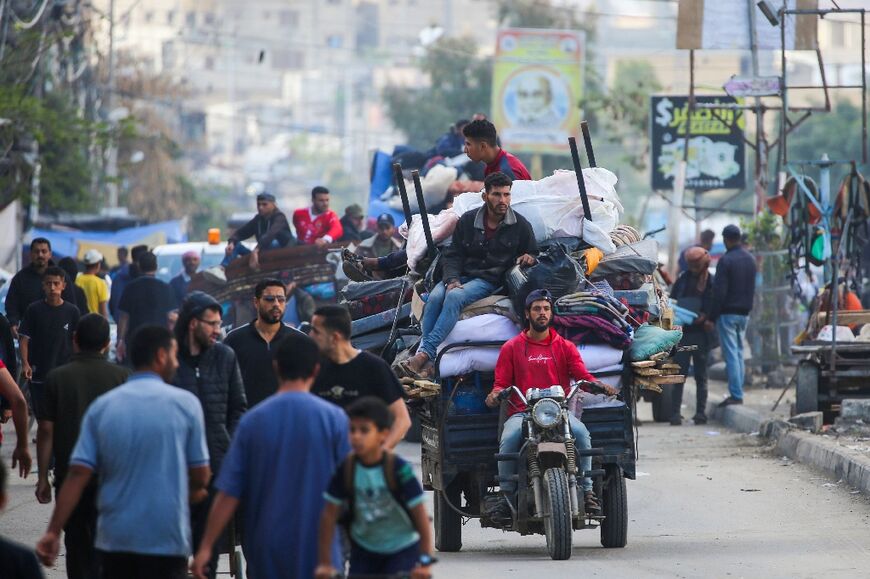 Displaced Palestinians flee Rafah with their belongings to safer areas in the southern Gaza Strip on May 7 after an evacuation order by the Israeli army