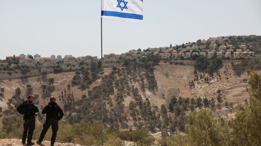 An Israeli flag flutters, as part of the Israeli settlement of Maale Adumim is visible in the background, in the Israeli-occupied West Bank, August 14, 2025. REUTERS/Ronen Zvulun