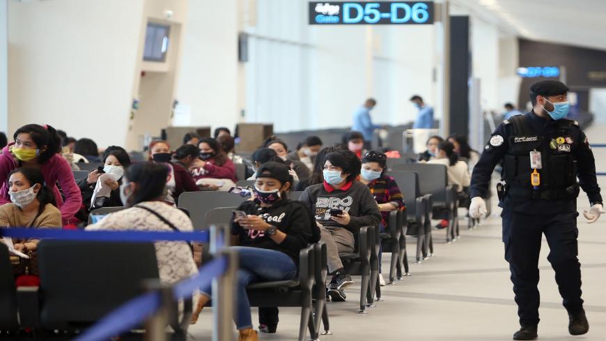 Filipinos who availed general amnesty granted by the Kuwaiti government are pictured gathering at the Kuwait International Airport Terminal 4, on their way home to Manila amid the coronavirus pandemic, April 3, 2020.