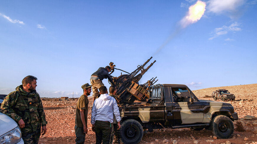 An anti-aircraft gun fires rounds in tribute during the funeral of General Wanis Bukhamada, commander of the "Saiqa" (Special Forces) of the self-proclaimed Libyan National Army (LNA) loyal to strongman Khalifa Haftar, in the eastern city of Benghazi on Nov. 1, 2020. 