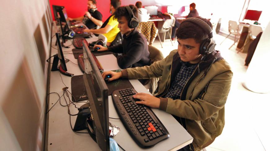 Youths play an online multiplayer game at an internet cafe in Iran's capital Tehran on January 24, 2021. 
