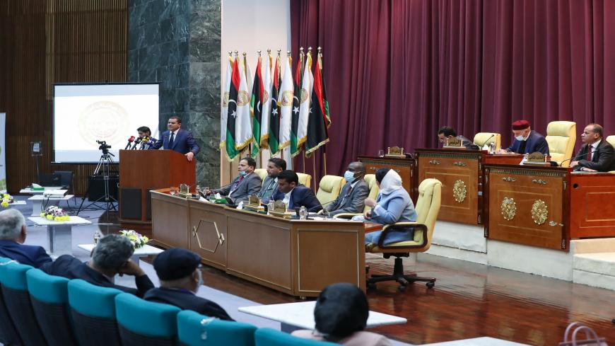 Libya's Prime Minister-designate Abdul Hamid Dbeibah addresses lawmakers during the first reunited parliamentarian session, in the coastal city of Sirte, Libya, March 9, 2021.
