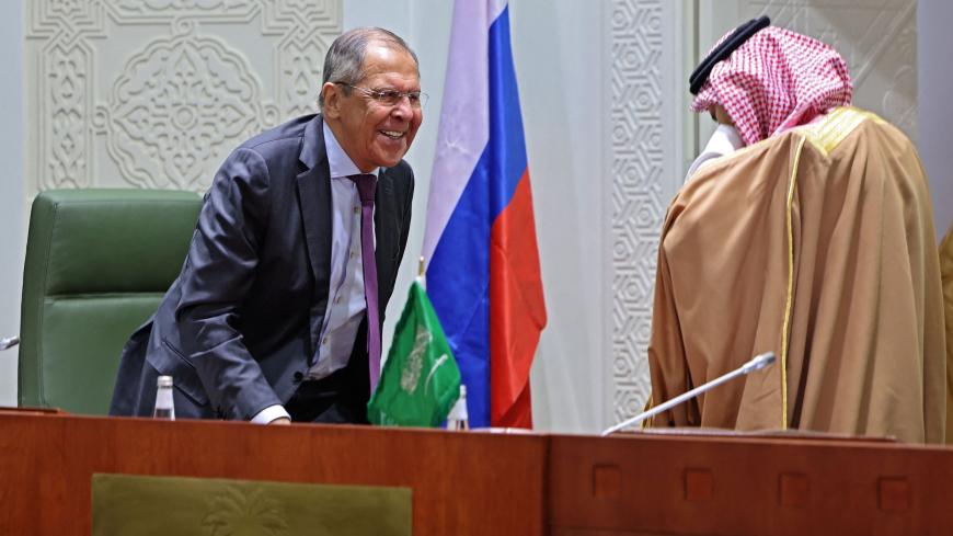 Russian Foreign Minister Sergei Lavrov (L) and his Saudi counterpart Faisal Bin Farhan chat ahead of a joint press conference following their meeting in the capital Riyadh, on March 10, 2021. 