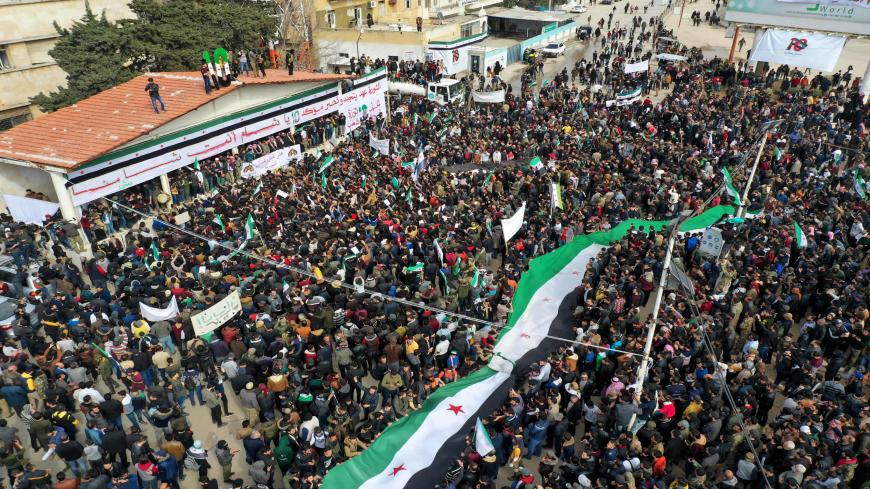 An aerial picture shows Syrians waving the opposition flag during a gathering in the rebel-held city of Idlib, as they mark 10 years since the nationwide anti-government protests that sparked the country's devastating civil war, Syria, March 15, 2021.