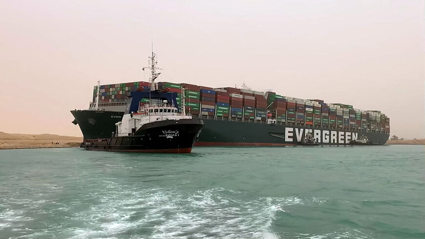 A handout picture released by the Suez Canal Authority shows the Taiwan-owned MV Ever Given (Evergreen) lodged sideways and impeding all traffic across the waterway of the Suez Canal, Egypt, March 24, 2021,