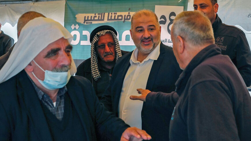 Mansour Abbas (C), head of Israel's conservative Islamic Raam party, speaks to supporters during a political gathering to congratulate him on the electoral victory in the northern Israeli village of Maghar on March 26, 2021.