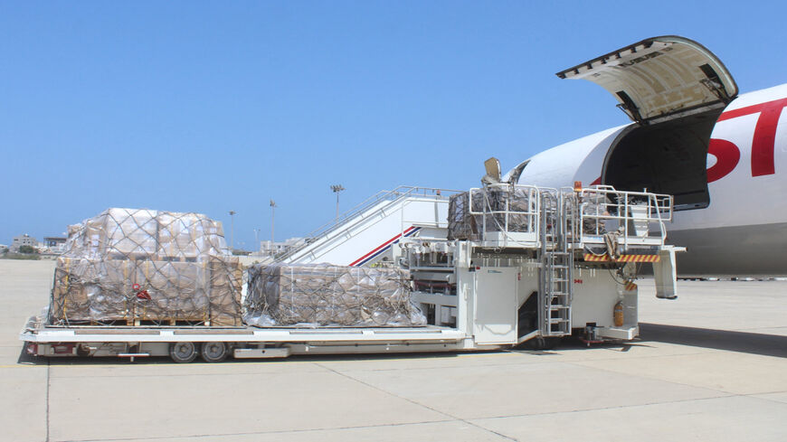 Boxes containing vials of the AstraZeneca/COVISHIELD vaccine (a version of the vaccine produced in India) against the coronavirus, are unloaded upon the arrival of the first shipment at the airport of Yemen's southern port city of Aden, on March 31, 2021. 