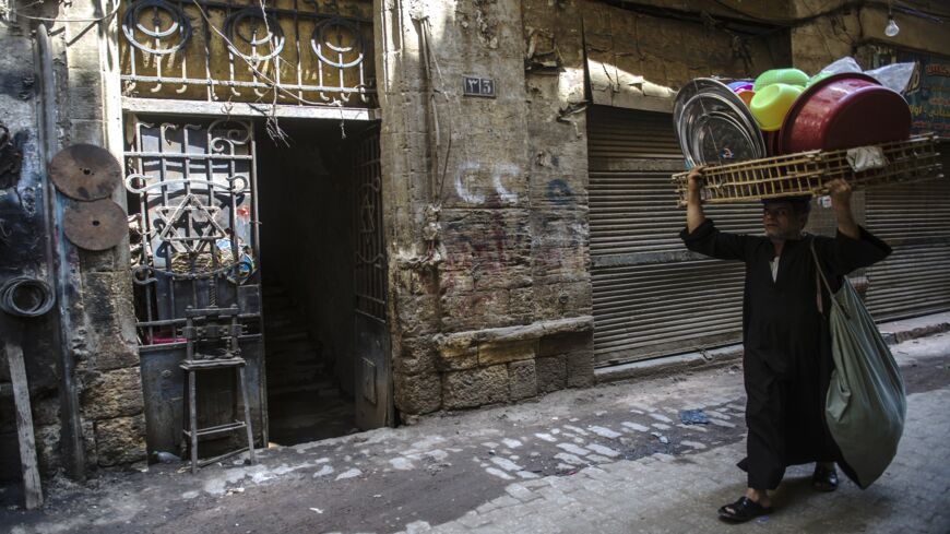 A man walks carrying dishes past a Star of David decorating the door of a home in the Jewish quarter of the Egyptian capital, Cairo, on June 25, 2015.