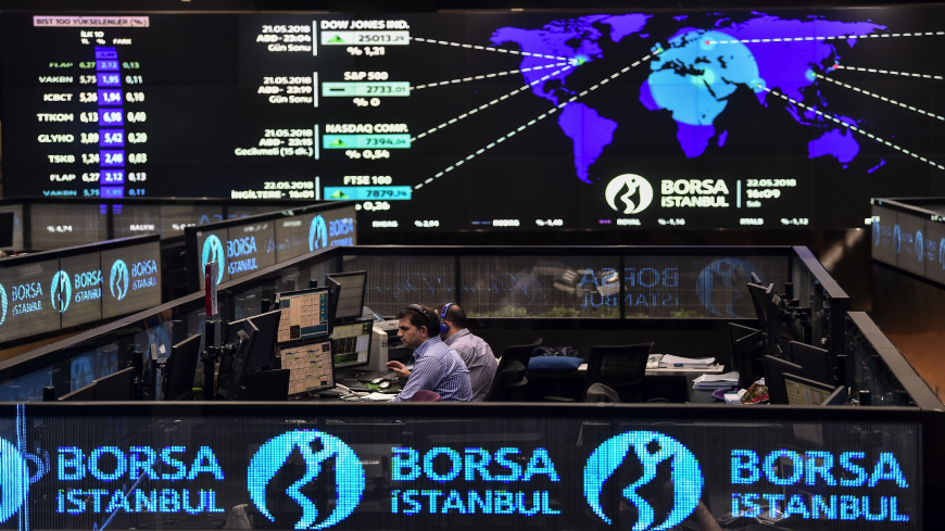 Traders work at their desks on the floor of the Borsa Istanbul in Istanbul on May 22, 2018. - Turkey's embattled currency, the lira, has hit new historic lows against the US dollar after Fitch ratings agency expressed concerns over the central bank's independence in the wake of comments by President Recep Tayyip Erdogan. (Photo by OZAN KOSE / AFP)