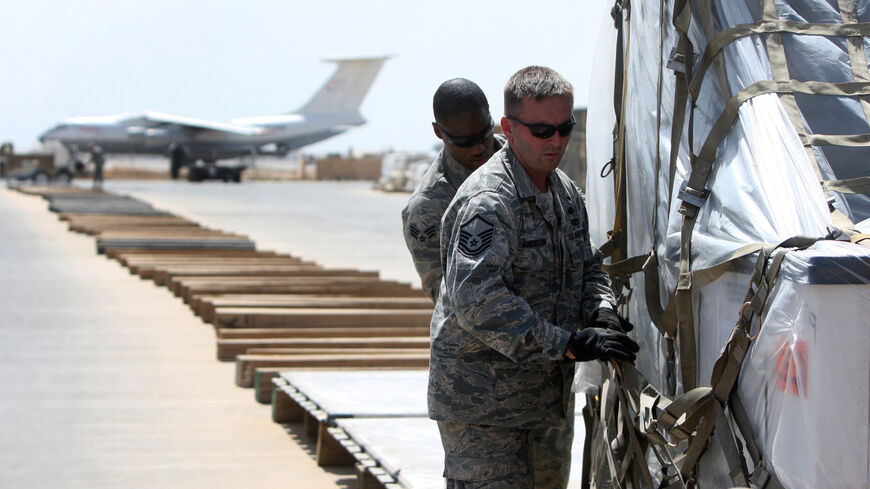 US soldiers load cargo into planes during a logistical operation to clear equipment and heavy machinery from the Balad military base, north of Baghdad, on Aug. 27, 2010 a week before the US military is due to end its combat mission in the country. 