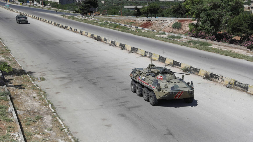 Russian armored vehicles drive as part of a joint Turkish-Russian military patrol along the M4 highway, which links the northern provinces of Aleppo and Latakia, near Ariha in the rebel-held northwestern Idlib province, Syria, June 10, 2020.