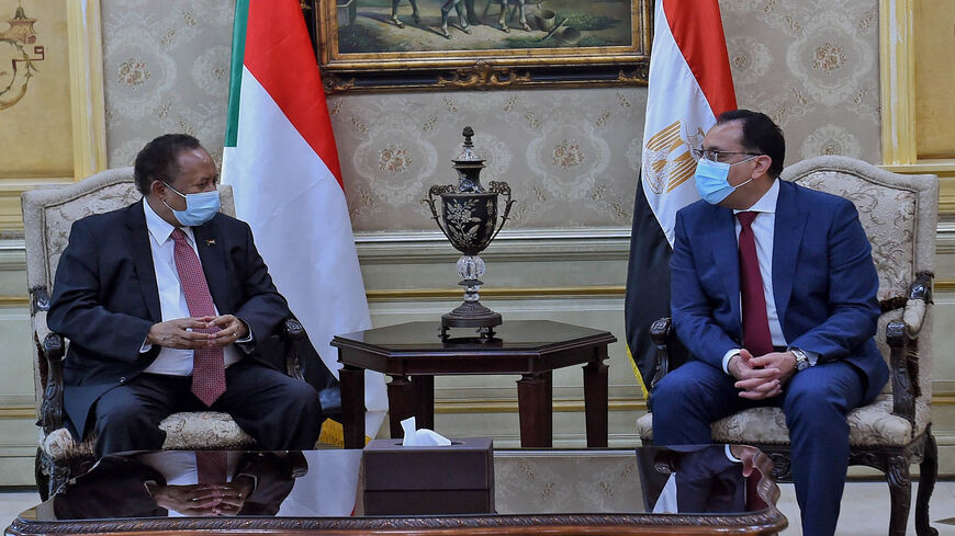 Egyptian Prime Minister Mustafa Madbouly (R) and his Sudanese counterpart Abdalla Hamdok meet in Cairo, Egypt, March 11, 2021.