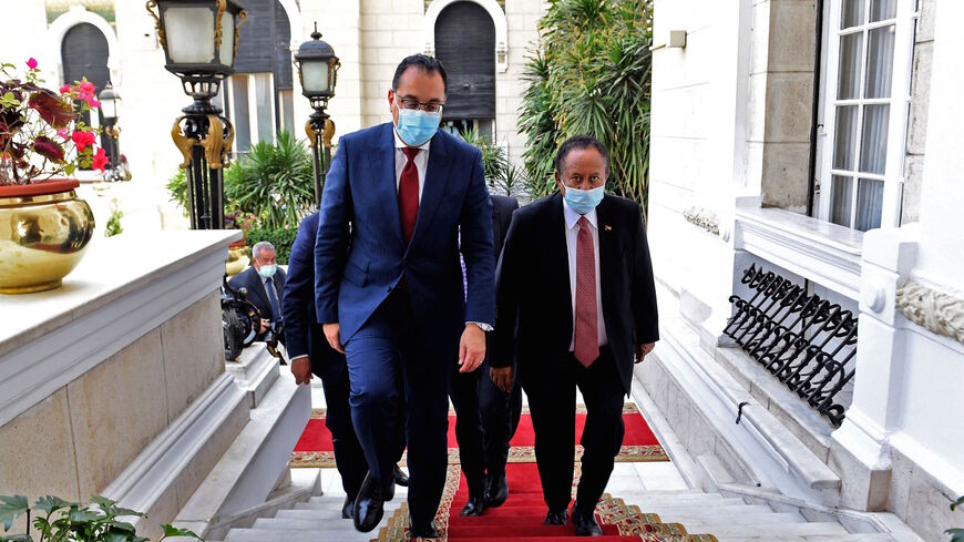 Egyptian Prime Minister Mostafa Madbouly (L) receives his Sudanese counterpart Abdalla Hamdok in the Egyptian capital Cairo, on March 11, 2021.