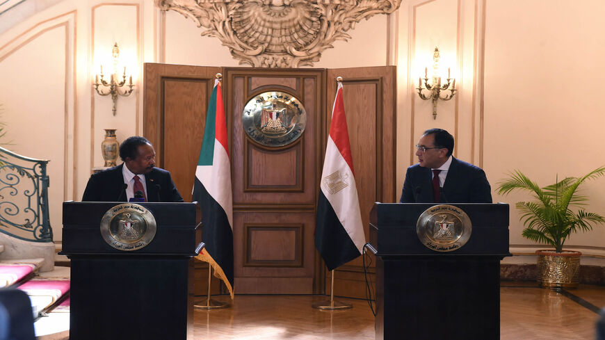 Egyptian Prime Minister Mustafa Madbouly (R) and his Sudanese counterpart Abdalla Hamdok give a joint press conference after meeting in Cairo, Egypt, March 11, 2021.