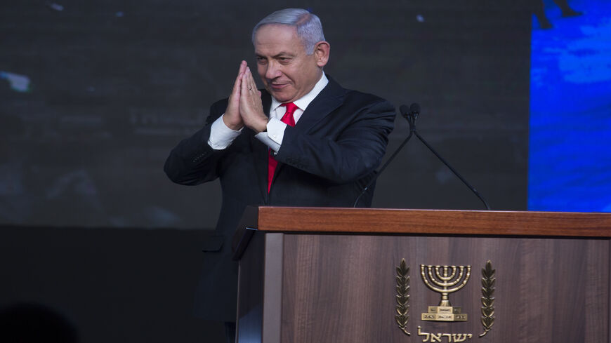 Israeli Prime Minster Benjamin Netanyahu greets supporters as he speaks at a Likud party gathering after a vote event, Jerusalem, March 24, 2021.