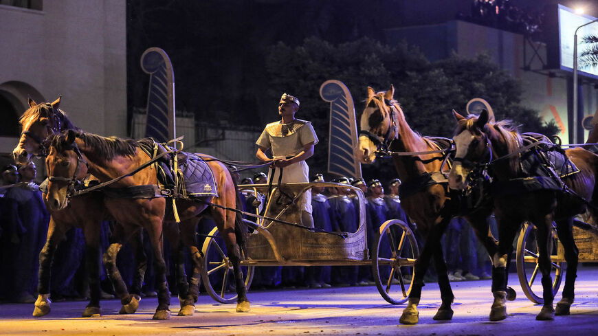 A performer rides a two-horse chariot at the start of the parade of 22 ancient Egyptian royal mummies departing from the Egyptian Museum in Tahrir Square to the new National Museum of Egyptian Civilization in Fustat, Cairo, Egypt, April 3, 2021.