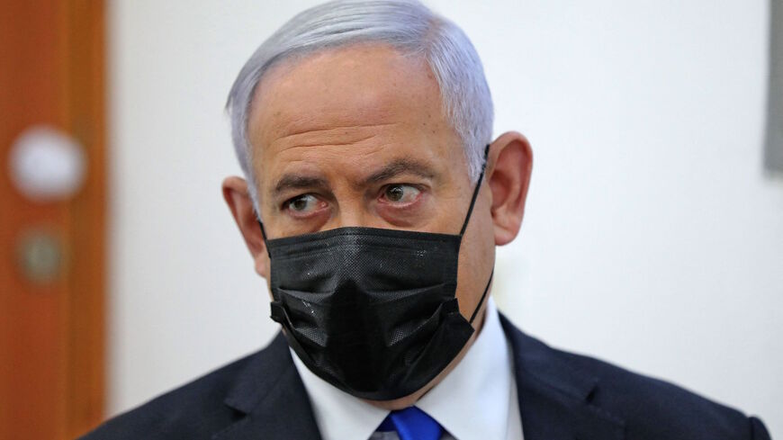 Israeli Prime Minister Benjamin Netanyahu (C-R) attends the hearing for his corruption trial at district court in Jerusalem on April 5, 2021. 