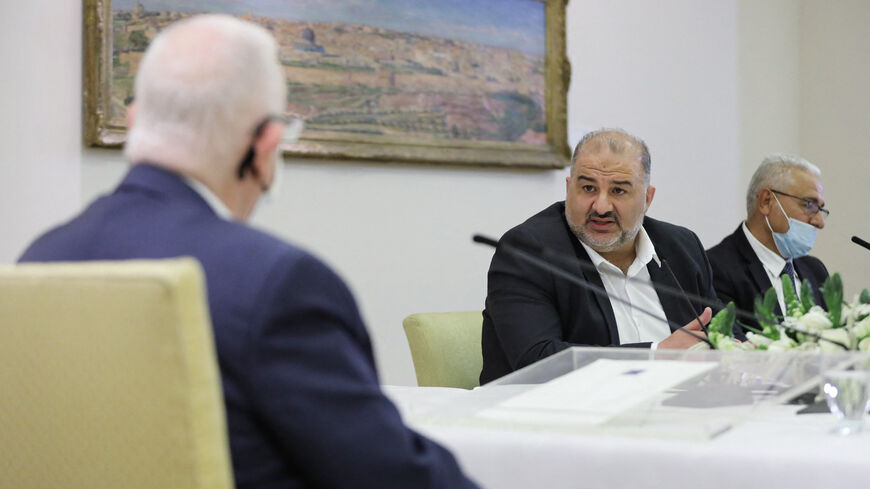 Israeli Arab politician, leader of the United Arab list, Mansour Abbas (C) attends consultations with Israeli President Reuven Rivlin (L) on who might form the next coalition government, at the President's residence in Jerusalem, on April 5, 2021. 