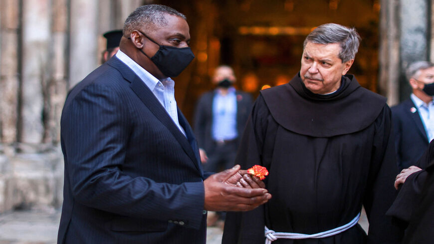US Defense Secretary Lloyd Austin (L) speaks with Franciscan monks outside the Church of the Holy Sepulchre, traditionally believed to be the burial site of Jesus Christ, in Jerusalem's Old City, April 11, 2021.
