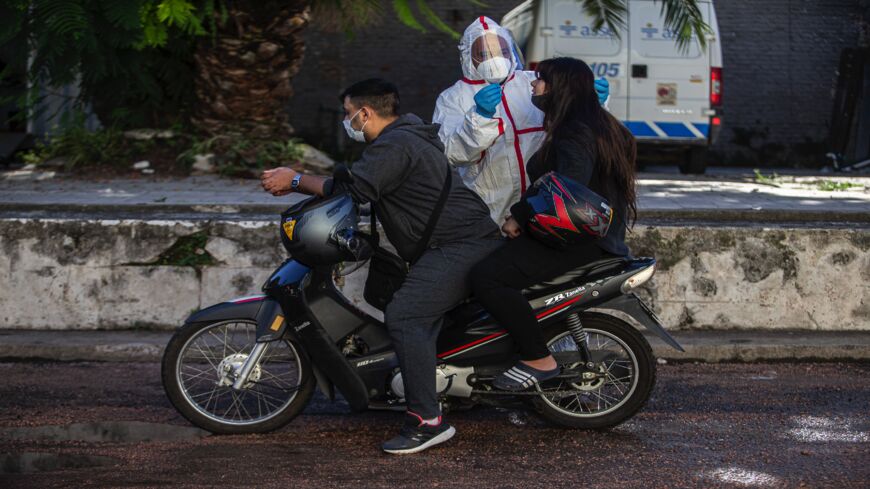 A person is tested with a COVID-19 PCR exam on April 14, 2021, in Montevideo, Uruguay. After cases surged in the last week, Uruguay has the highest rate of COVID-19 infections per million inhabitants in Latin America, surpassing Brazil and Mexico. The South American country, which has a population of 3.4 million, currently has the highest global rate of new positive cases of coronavirus.