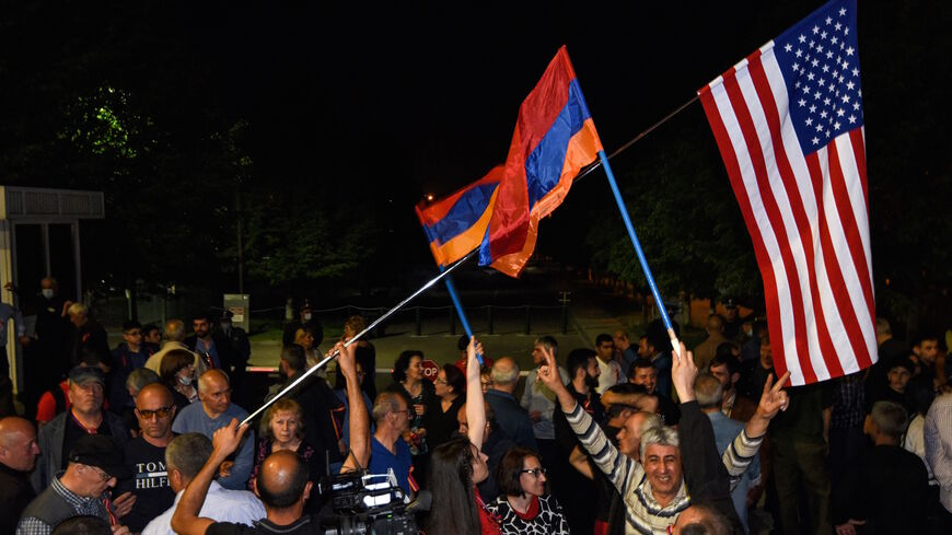 People wave Armenian and US flags in front of the US embassy in Yerevan after US President recognized the 1915 killings of Armenians by Ottoman forces as genocide, on April 24, 2021. 