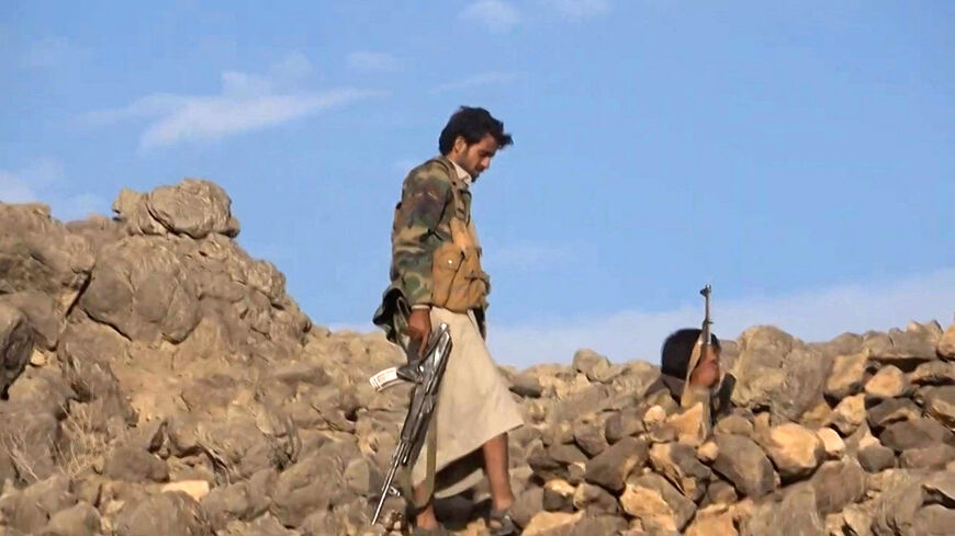 A grab from an AFPTV video taken on April 25, 2021, shows fighters loyal to the Saudi-backed Yemeni government along the Mashgah frontline against Houthi rebel forces near the contested northeastern city of Marib.