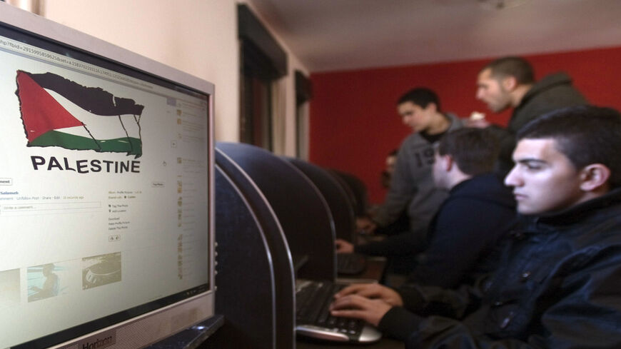 Palestinian youths check their Facebook accounts at an internet cafe, Ramallah, West Bank, Jan. 6, 2012.